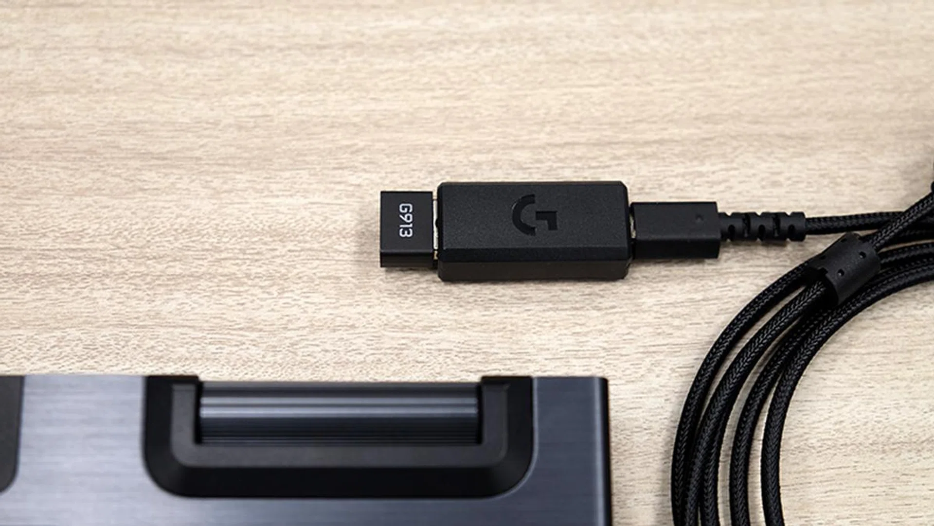 An included adapter will let you connect the dongle to the cable and bring it closer to the keyboard.