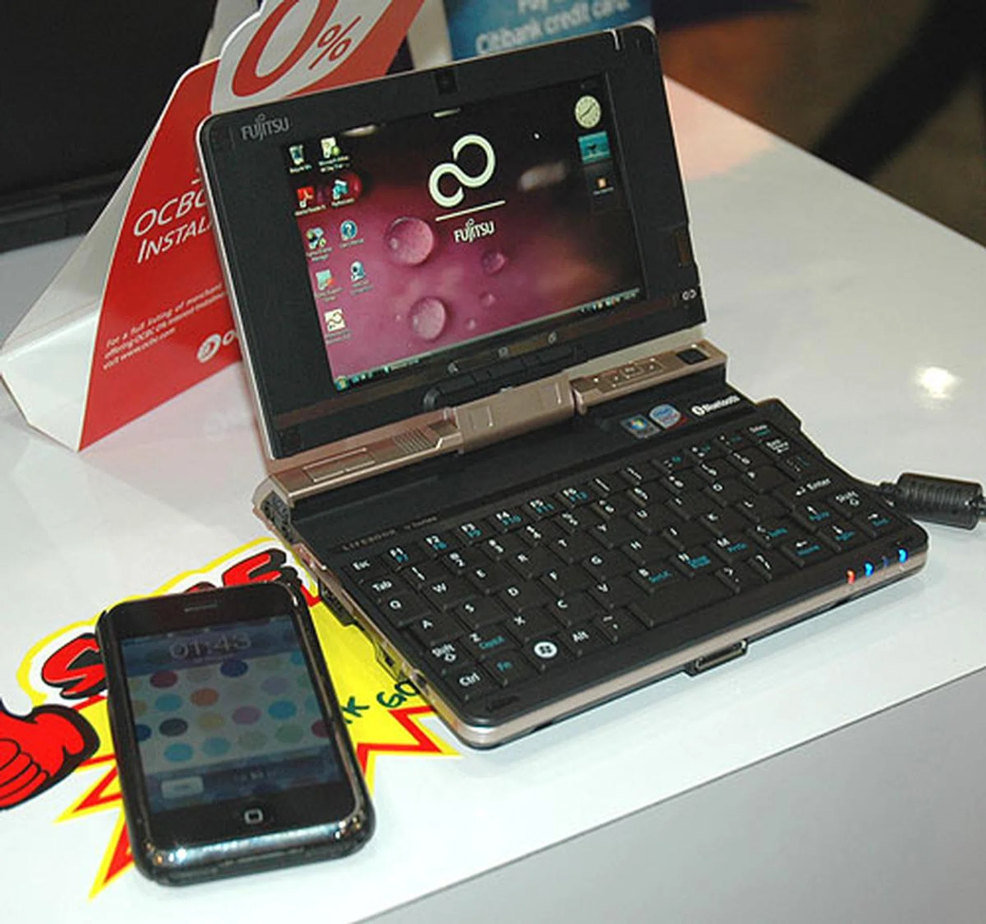  At S$1,618, the Fujitsu LifeBook U2010 is probably one of the most expensive Atom powered device you'll find. Here's how small it is, lying besides an iPhone.  