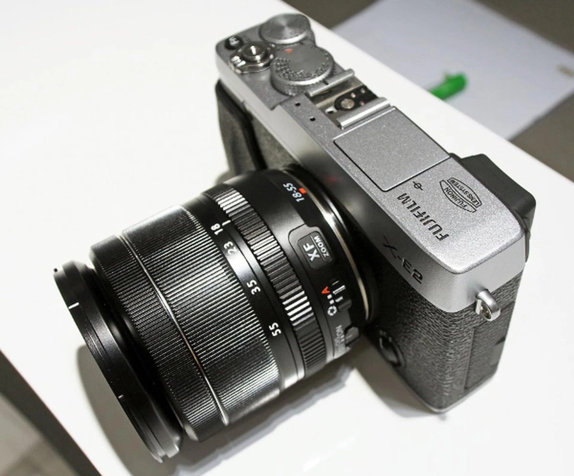 The X-E2 comes with an internal flash unit in case you don't want to spring for an external one at the moment.