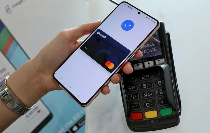 Android phone user pairs EZ-Link's and Mastercard's Pay By Wallet to Google Pay for payment.