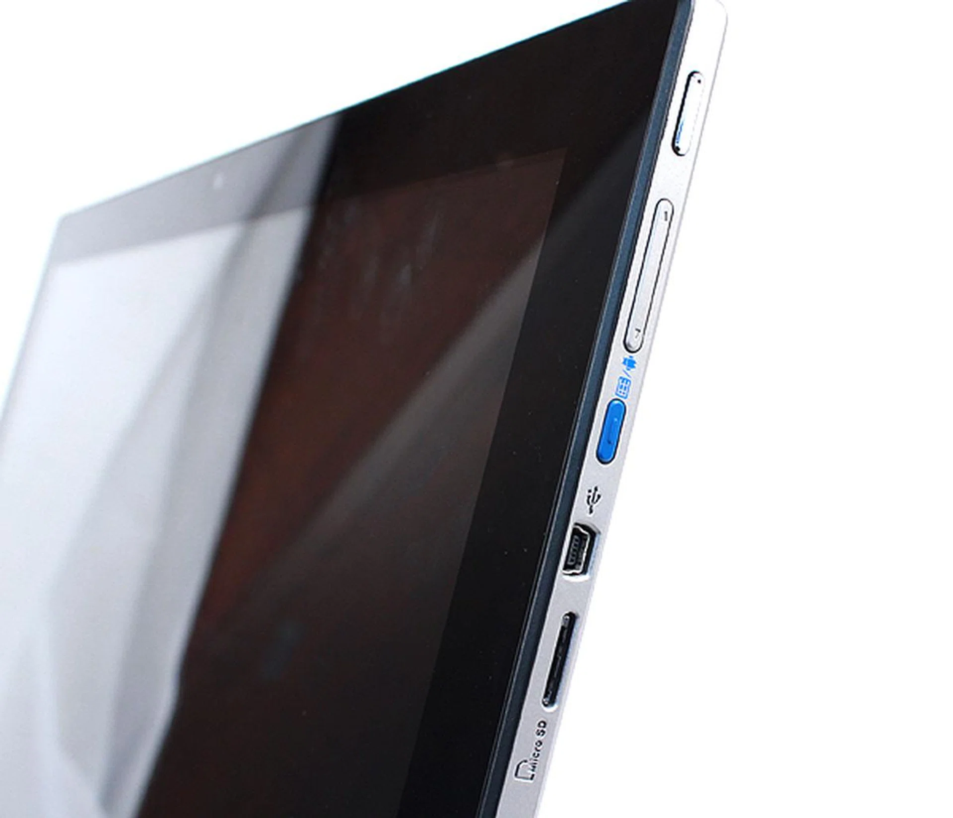 To the right of the tablet are the main buttons and ports. The top most button acts like a "Home" key and the button below it lets you adjust the tablet's volume. When the tablet is docked, bright blue button toggles between the tablet's Android OS and the AIO machine's Windows OS. Finally, there's a mini-USB port and a microSD card slot.