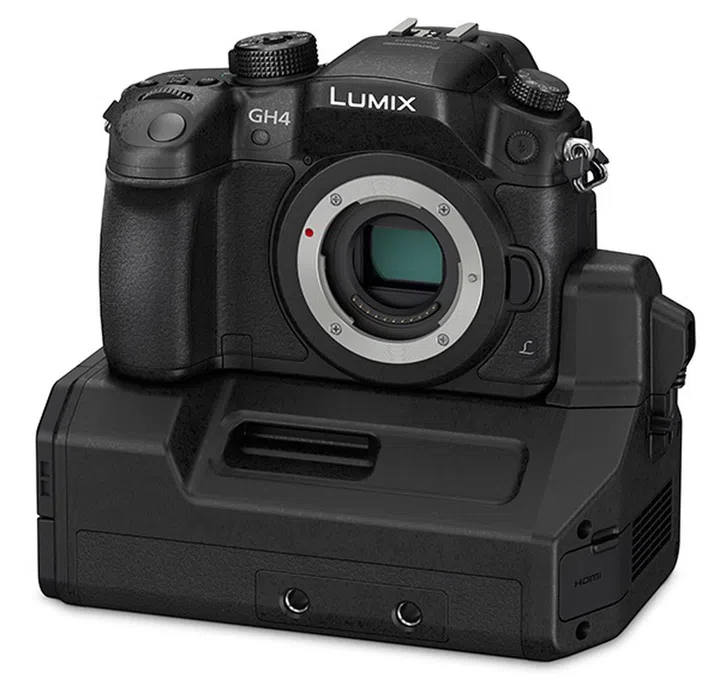 That large attachment is the new Interface Unit for professionals. It has four parallel outputs which can be used for Full-HD and 4K output with time code. An XLR input terminal can connect a line or condenser microphone. The attachment also doubles as a battery pack to provide the GH4 with more power.