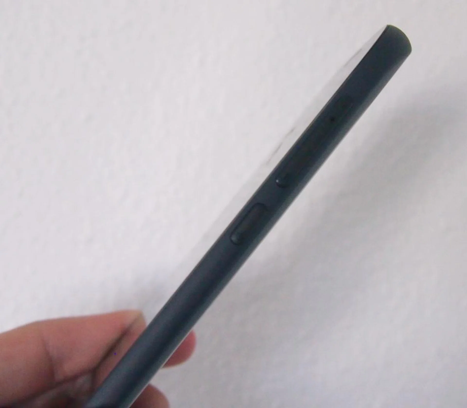 The volume controls and power button are easily accessible on the right side of the YotaPhone 2. You need a pin to eject the nano-SIM card tray, which is essentially the volume rocker.