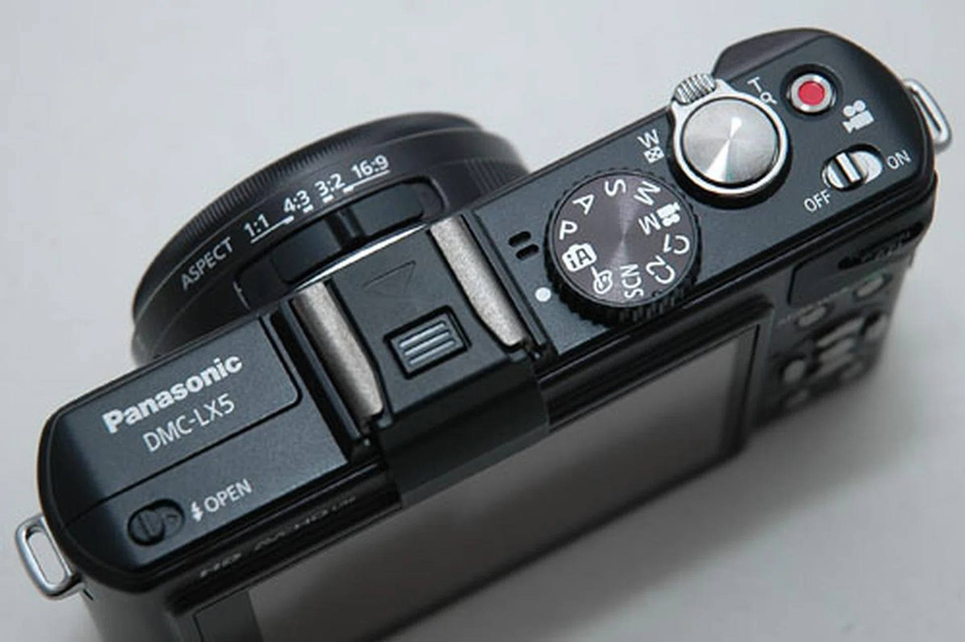 Note the new bright red movie record button next to the shutter release, as well as the 1:1 aspect ratio switch on the lens. 