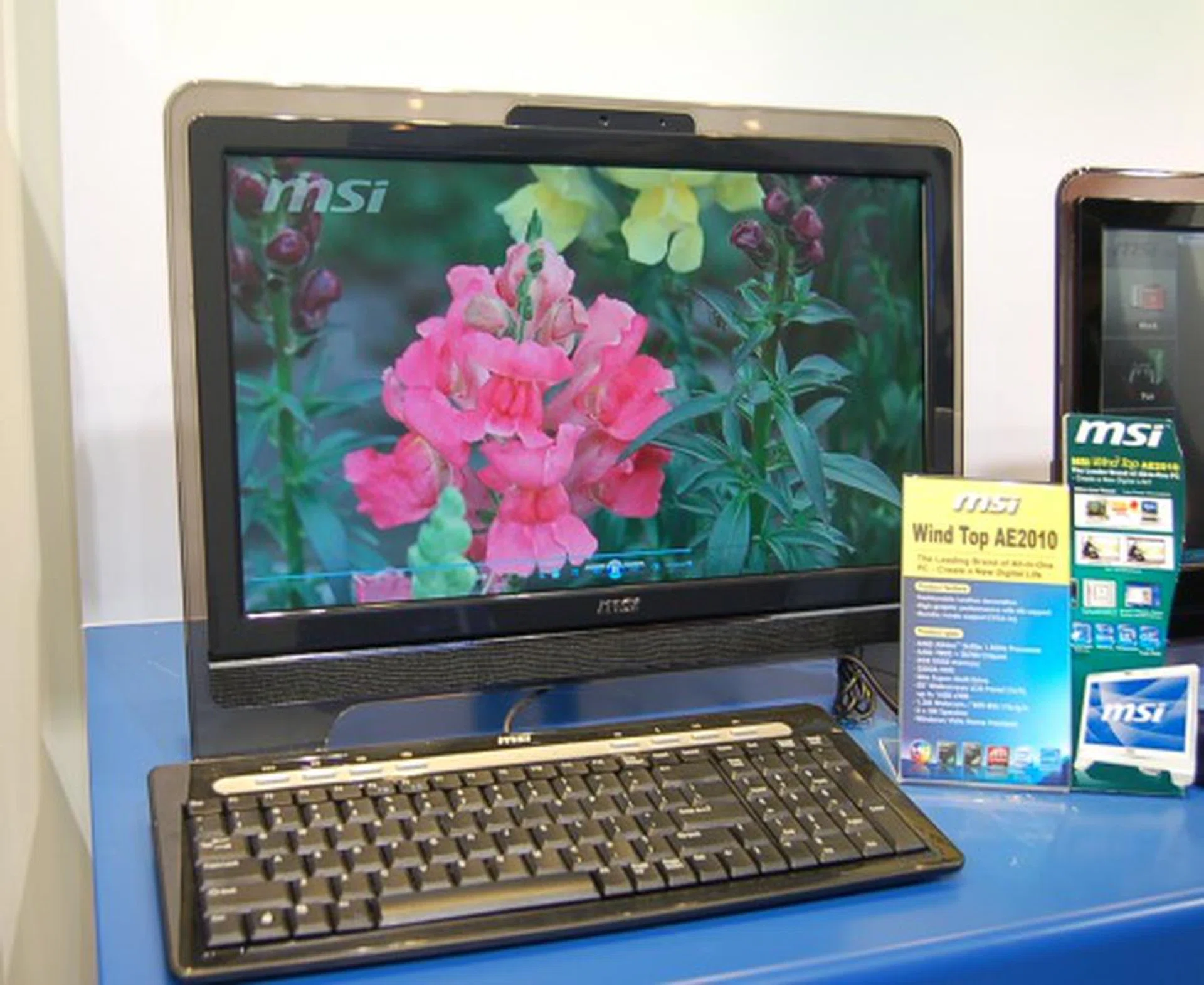  This however is their brand new all-in-one system, the Wind Top series. This model here is the AE2010 and is equipped with a 20-inch screen, 16: 9 aspect ratio, 1600x900 resolution, 1.3MP webcam, 3W hi-fi speakers, super-slim ODD, 320GB HDD, and is using an AMD 780G platform with a an Athlon 2650e 1.5GHz processor. Windows Vista Home Premium is standard on these machines. Available in 19-inch, 22-inch models, and on Intel platforms too.  