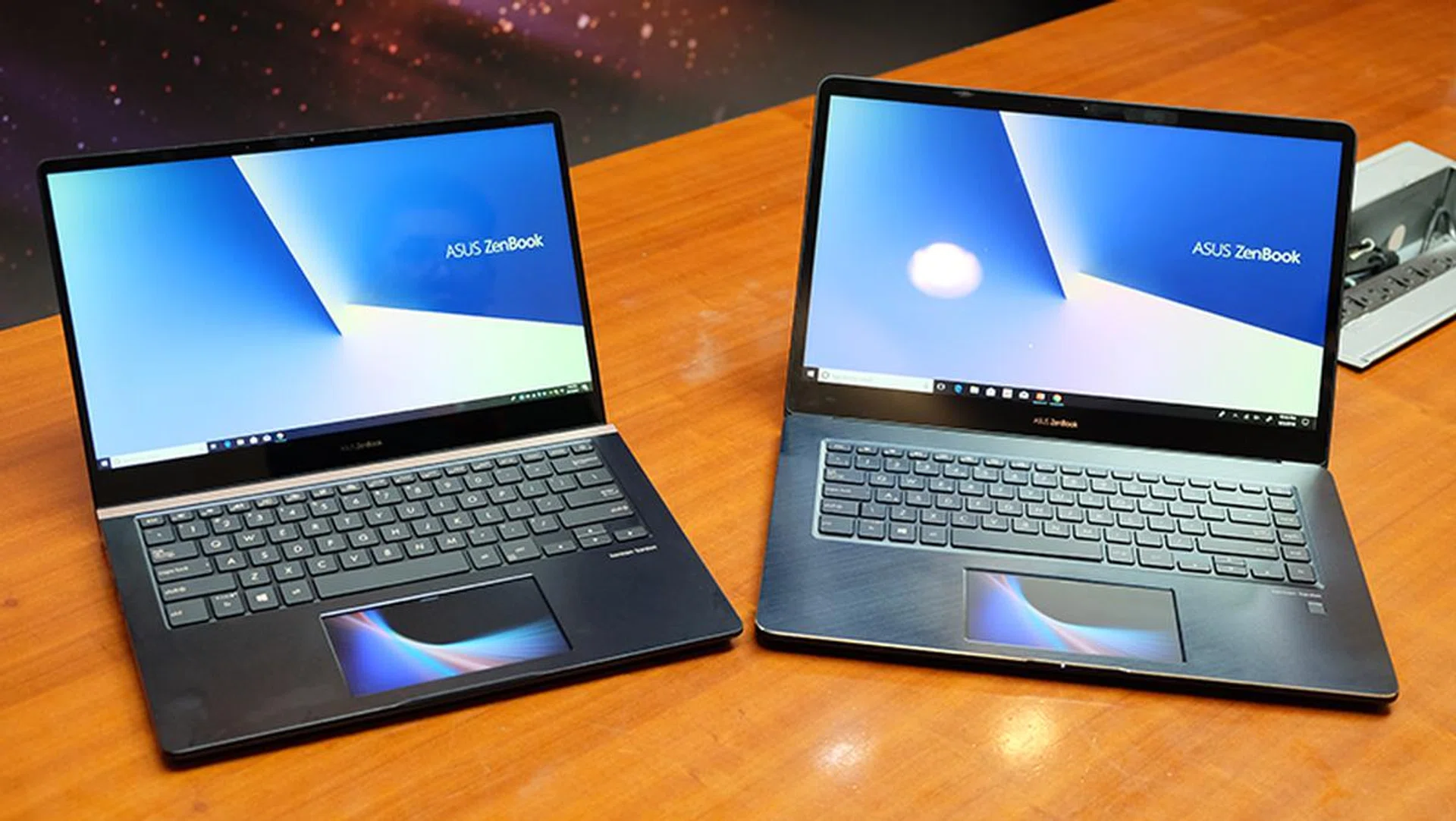The ZenBook Pro 14 (left) and 15 both feature the ScreenPad touchpad display.
