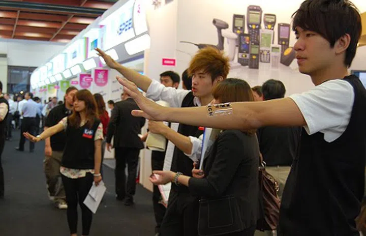 Folks playing Jedi mind tricks? Actually they are staff from arTouch, demoing their wireless motion sensing software with advanced webcams.