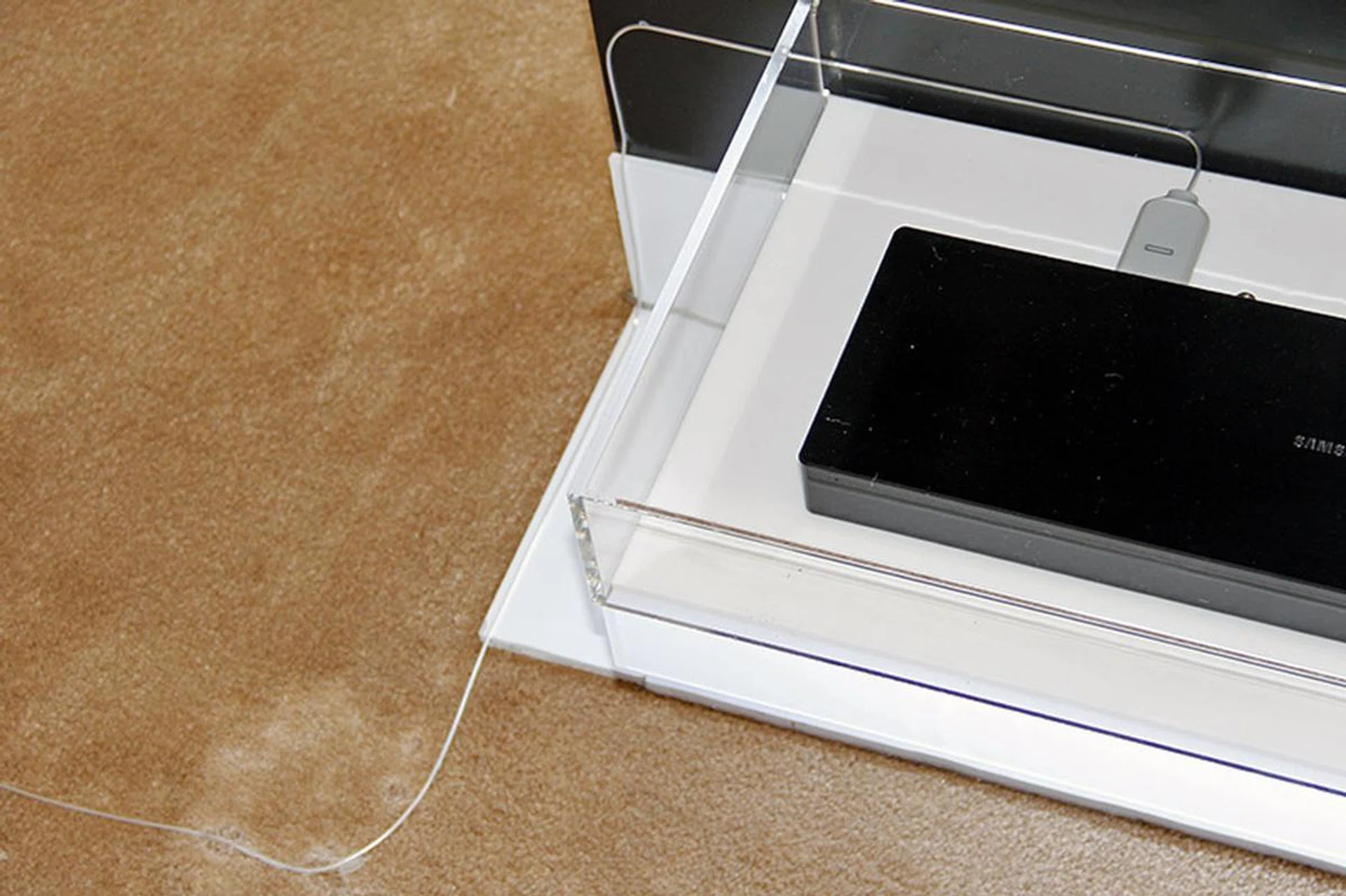 The other end of the Invisible Connection goes to the One Connect box, which houses the I/Os (e.g., HDMI inputs) that connect to your media boxes, game consoles, etc.