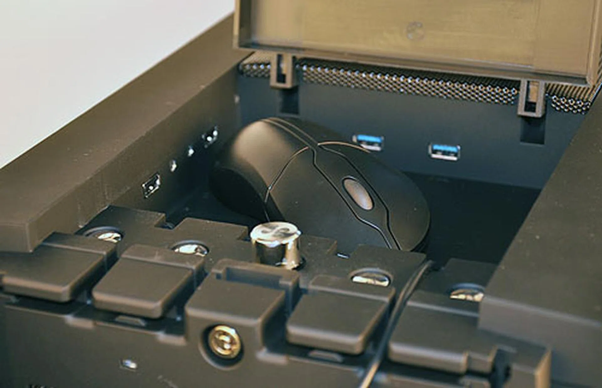 While we could fit our mouse within the S3 compartment, it's not that spacious and some of the taller mice or harder storage devices will not fit. Notice too that the casing's buttons, including the power, reset and fan control switches are found inside the compartment. Also, see the cable leading from the compartment? That too is a rather unique feature...