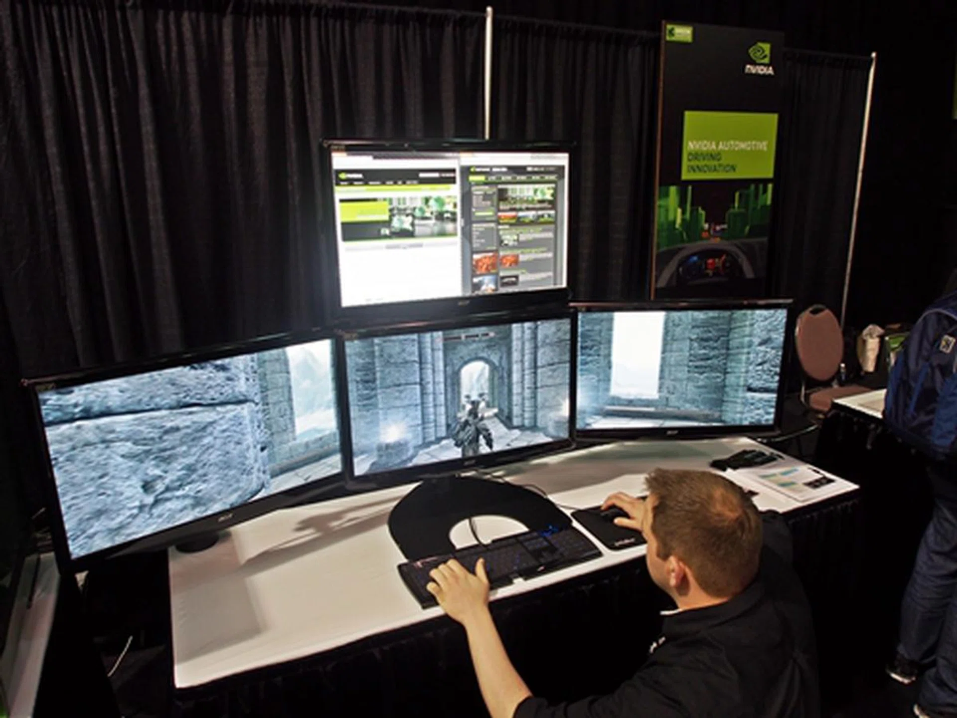 The four-monitor setup is powered by a pair of GeForce GTX 680 cards in SLI configuration. The game on display is Skyrim with its settings set at maximum to tax the pair of graphics cards. You can also note the 'accessory' display complimenting the main gameplay screens, though we're not totally sold of its usefulness.