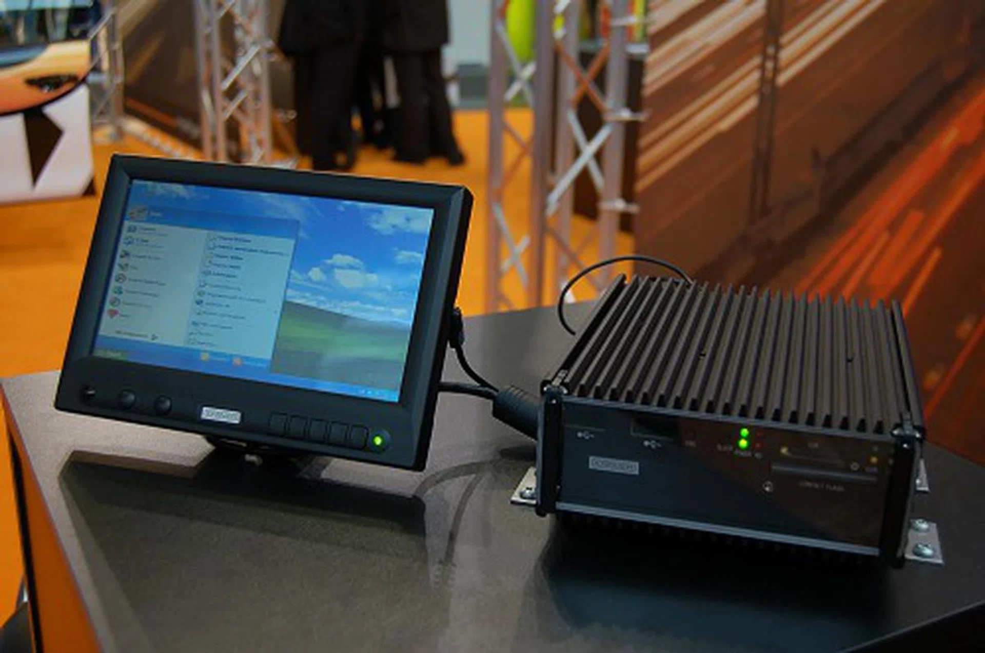  This is their CarPC-System CP-4000. It's a rugged looking PC that's to mounted at the bottom of the seat or in the boot of the car. Specs of the mini PC include an Intel Celeron C140 1GHz processor, 256MB RAM (expandable to 1GB), 20GB notebook HDD (has SSD options), Intel 855GME graphics onboard, WLAN module onboard (GSM module optional) and has a variety of I/O like USB ports, LAN port, VGA, LVDS, DVI and more. This unit weighs about 3kg. Kramer is aiming this unit at those who require complete PC functionality wherever they are, but this is more applicable for a variety of commercial uses like in logistics tracking on the move on more.  