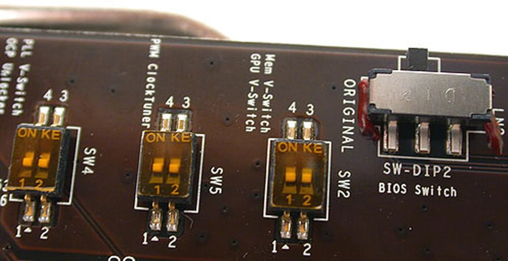 These are the switches that overclockers are looking for, allowing them to release the safeguards on overcurrent and push up the voltages. There's also a small BIOS switch at the side that restores the original BIOS in case users accidentally mess up the BIOS with a custom, OC firmware.