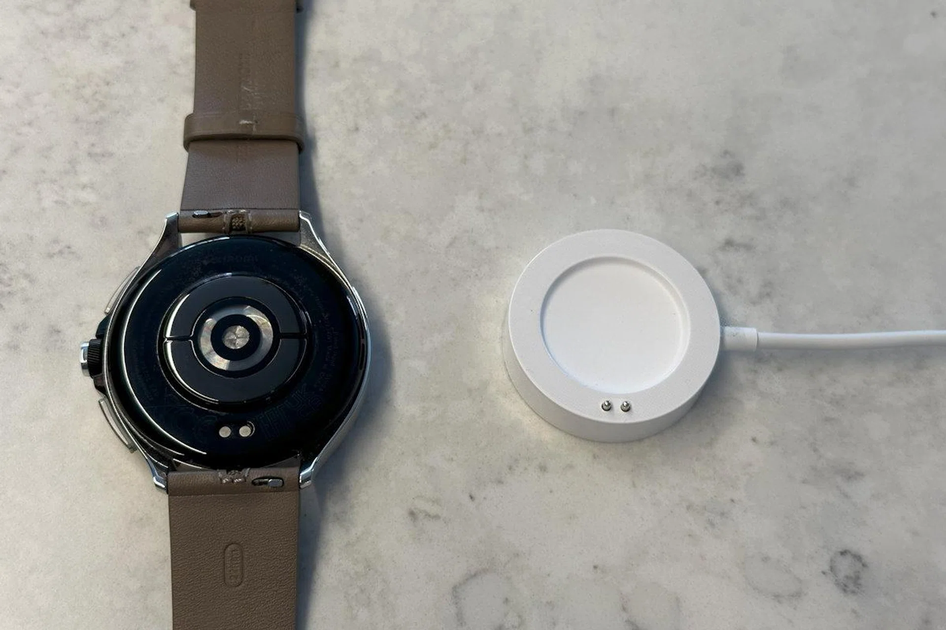 The Watch 2 Pro also uses a proprietary puck for charging.
