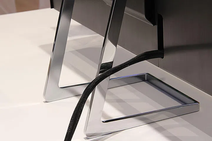 The video ports reside behind a panel at the back. Notice the brushed metal back too. The chrome stand is equally simple but elegant. And don't worry, this monitor tilts and pivots.