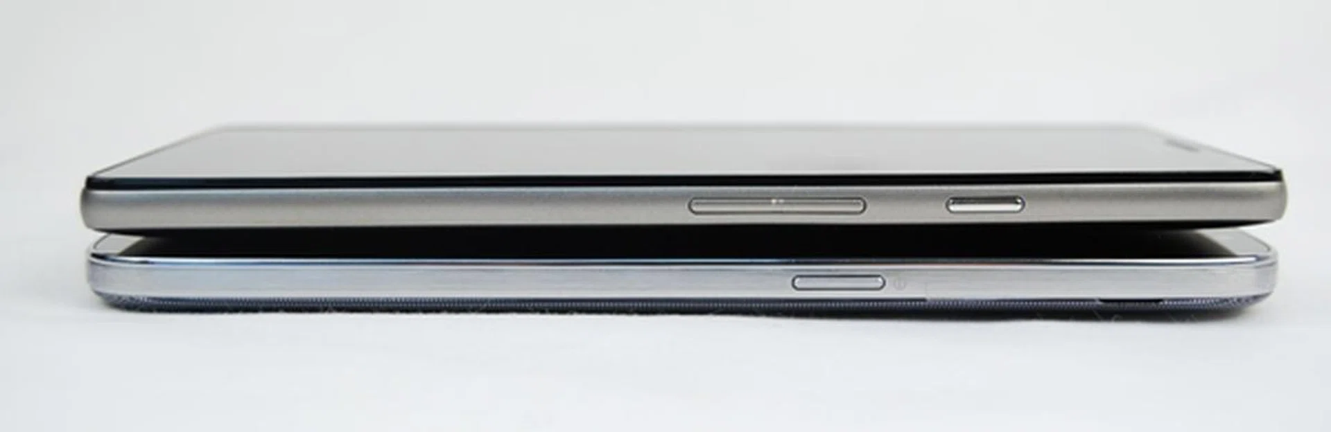 The Power button on the Samsung Galaxy Mega with LTE (bottom) is deliberately located closer to the middle for easier access so that you need not stretch your thumb. However, it's a little too accessible and easy to engage the button in casual handling - we've had our fare share of switching off the phone accidentally.