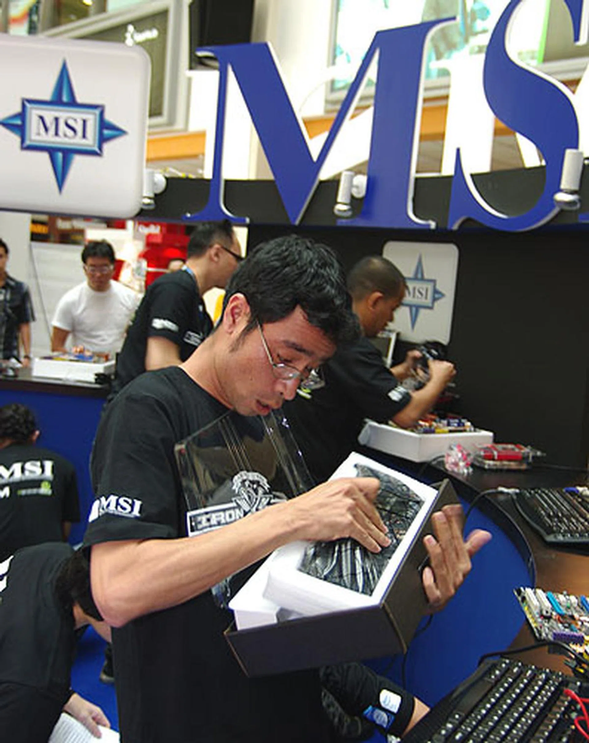  Thailand's Thirdsak Phokha struggling to get his graphics card out of the packaging.  