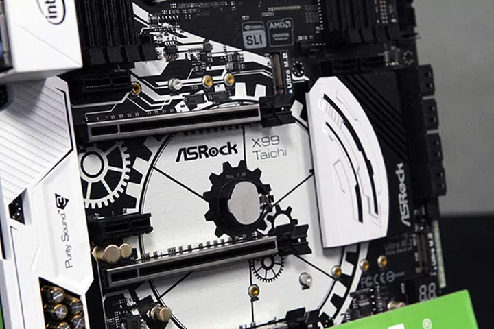 A pattern of white cogs and gears has been printed onto the PCB of the X99 Taichi. (Image Source: Tom's Hardware)