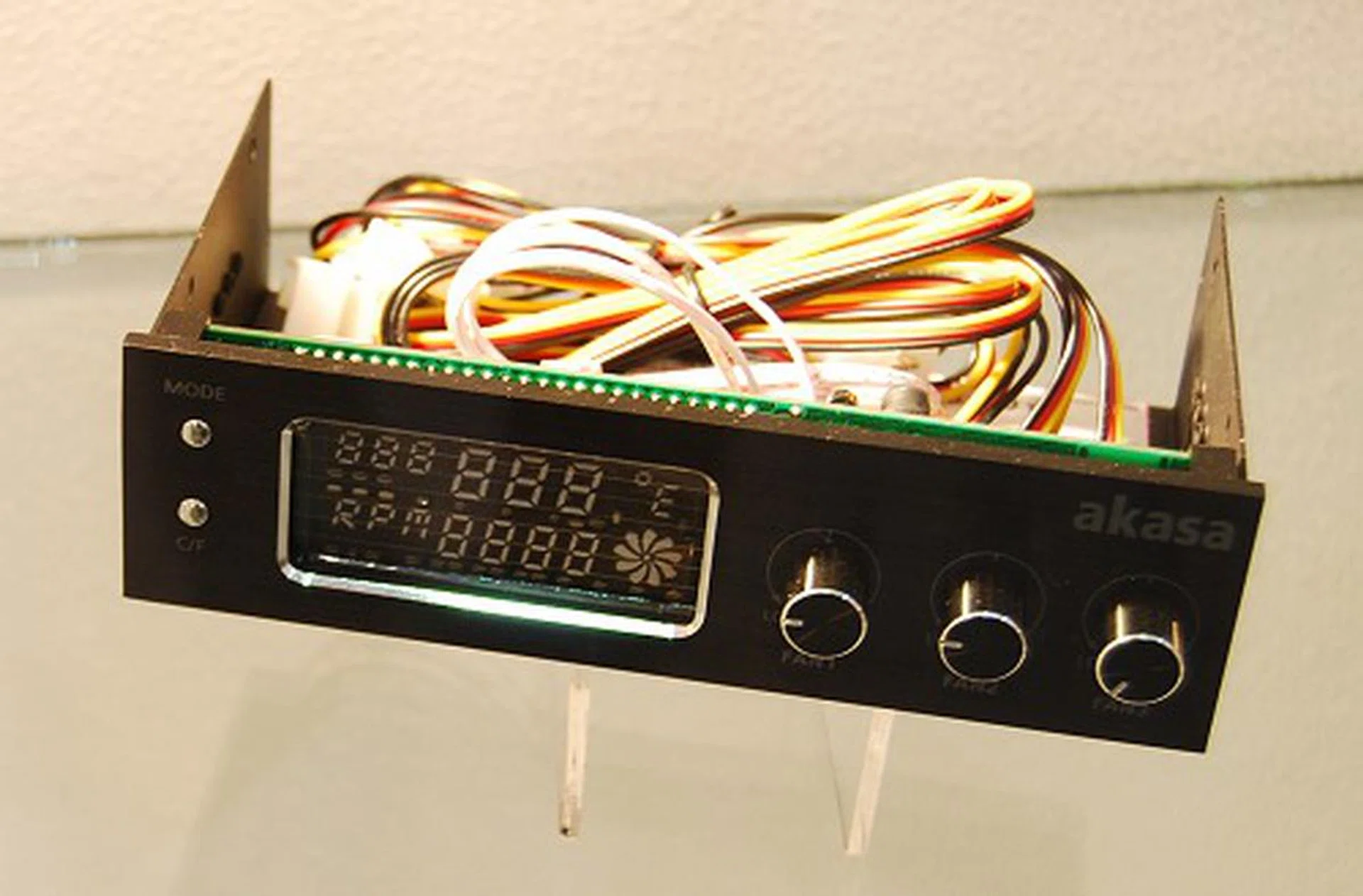 This is one of their newer front-panel accessories, the FC.Trio fan controller hub. With a brushed aluminum panel, tri-fan control a VFD display, you would wish it came bundled with the Venom casing.