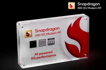 The Qualcomm Snapdragon X80 5G modem is encased in a block of showy glasstic at MWC 2024.