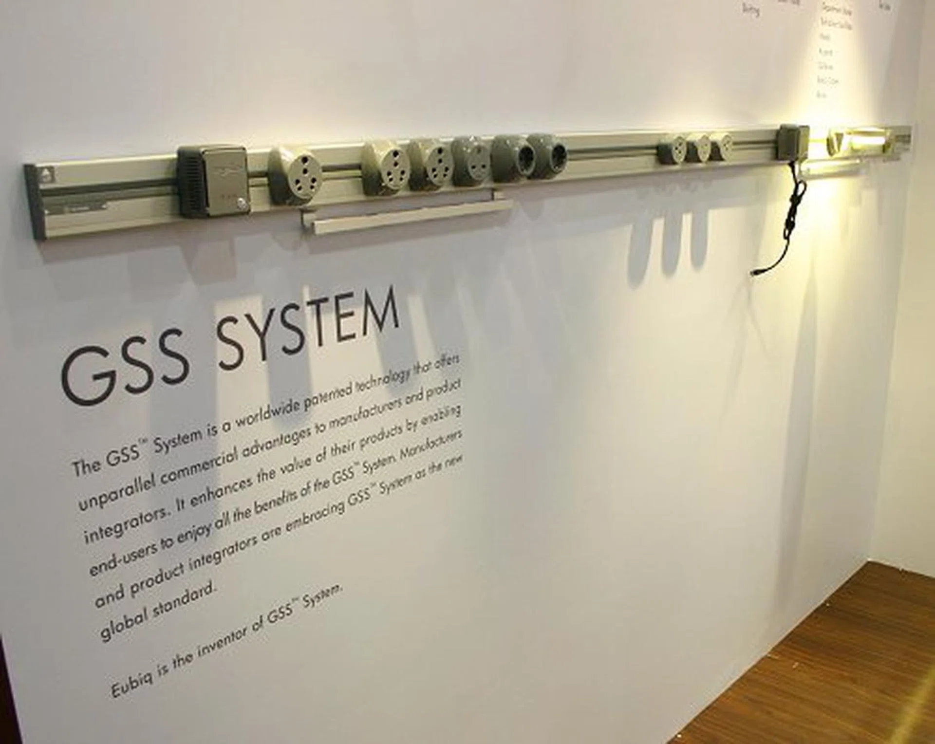  Originating from sunny Singapore, Eubiq delivers a whole new way of power delivery to devices. Shown above is the GSS system invented by Eubiq. With it, offices, homes and any place that requires numerous multi-port power points can now have a practical, safe and visually pleasing power outlet system that adds flexibility to the way you "plug" into power. Simply insert a plug into the track and you'll get instant power.  