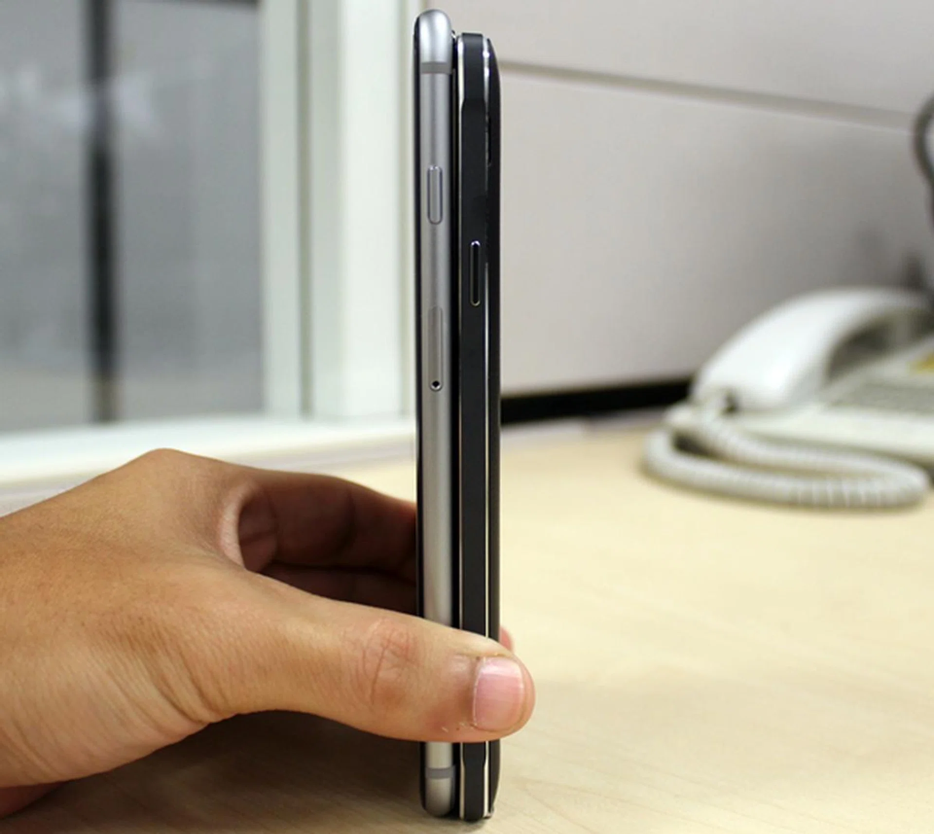 The Samsung Galaxy Note 4 (right) has a slightly bigger display at 5.7-inches, but the 5.5-inch Apple iPhone 6 Plus (left) is taller.