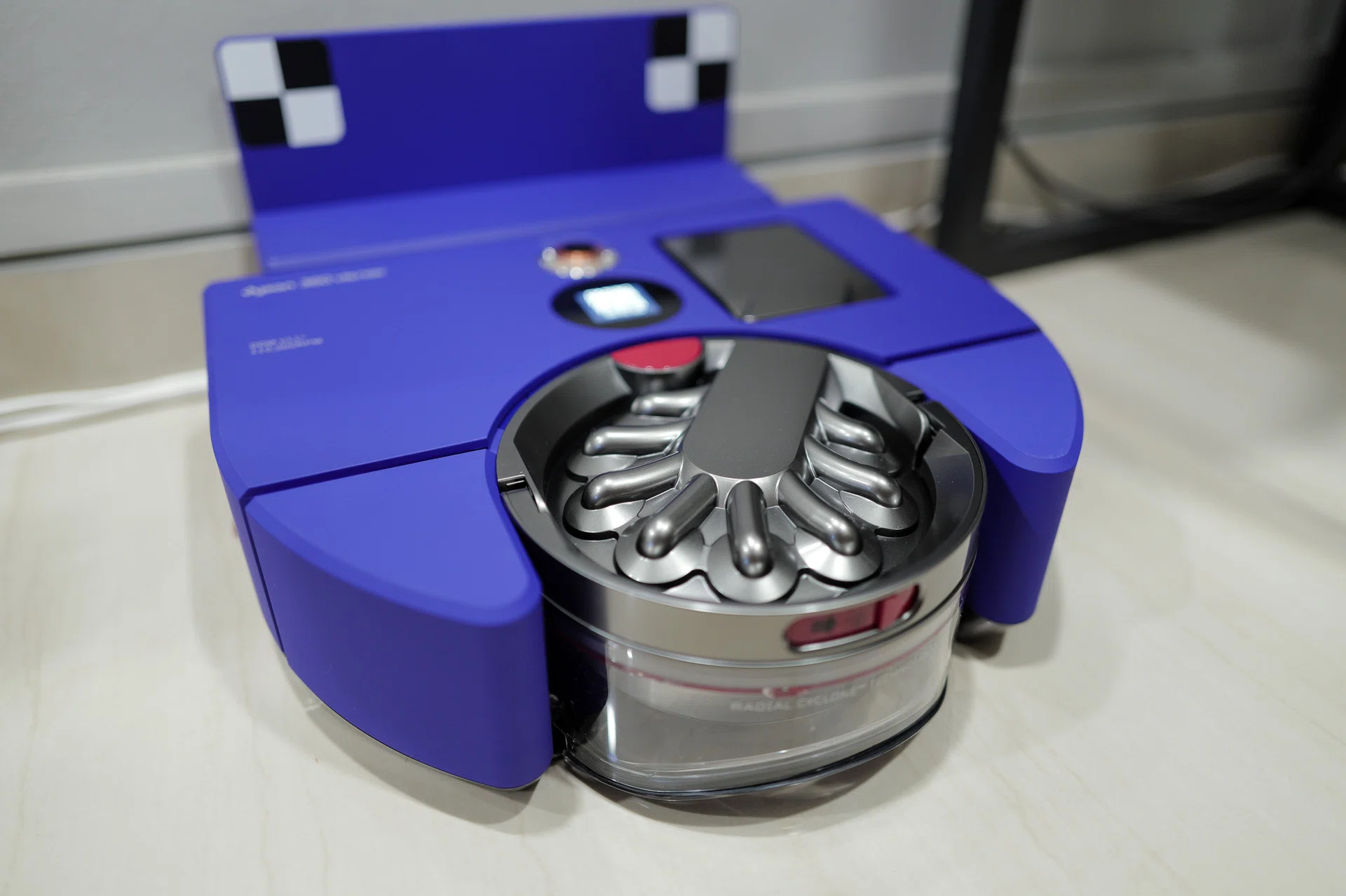 Interestingly, the robot vacuum identifies its docking station by the two checkered markers.