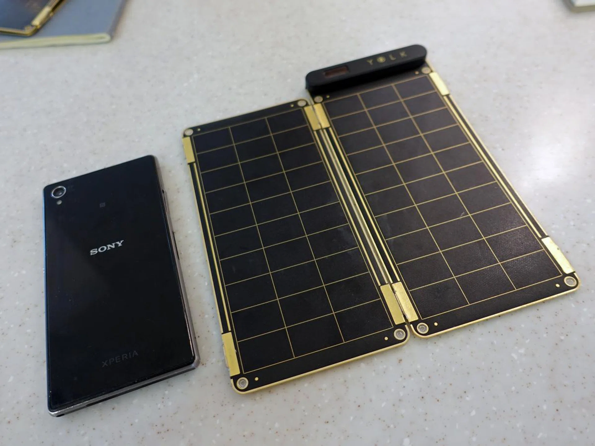 The Solar Paper (right) together with a 5.0-inch smartphone for size reference.