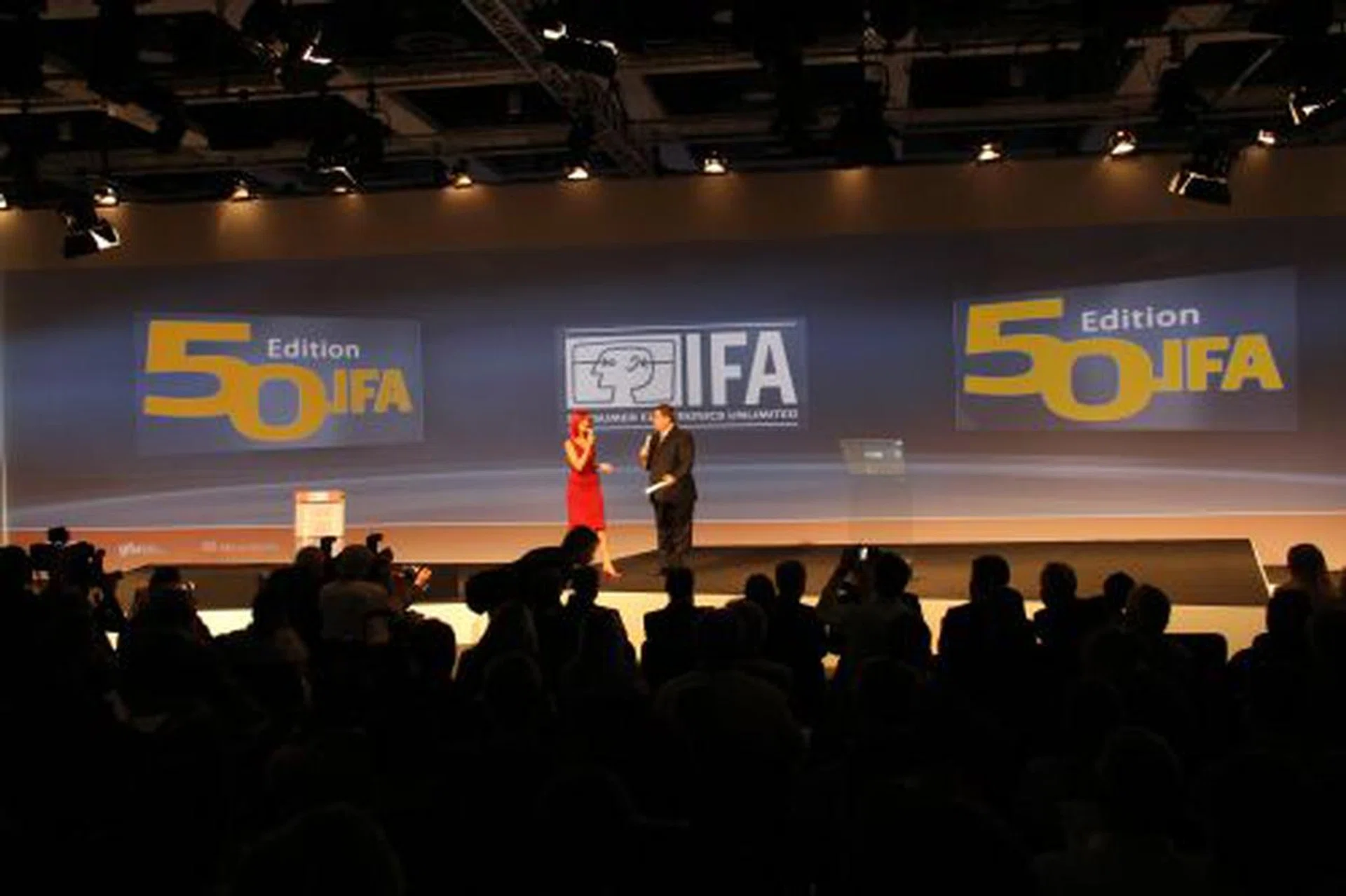 Miss IFA, the symbolic icon of the IFA consumer electronics show with her trademark red theme, greets journalists to the 50th edition of the show.