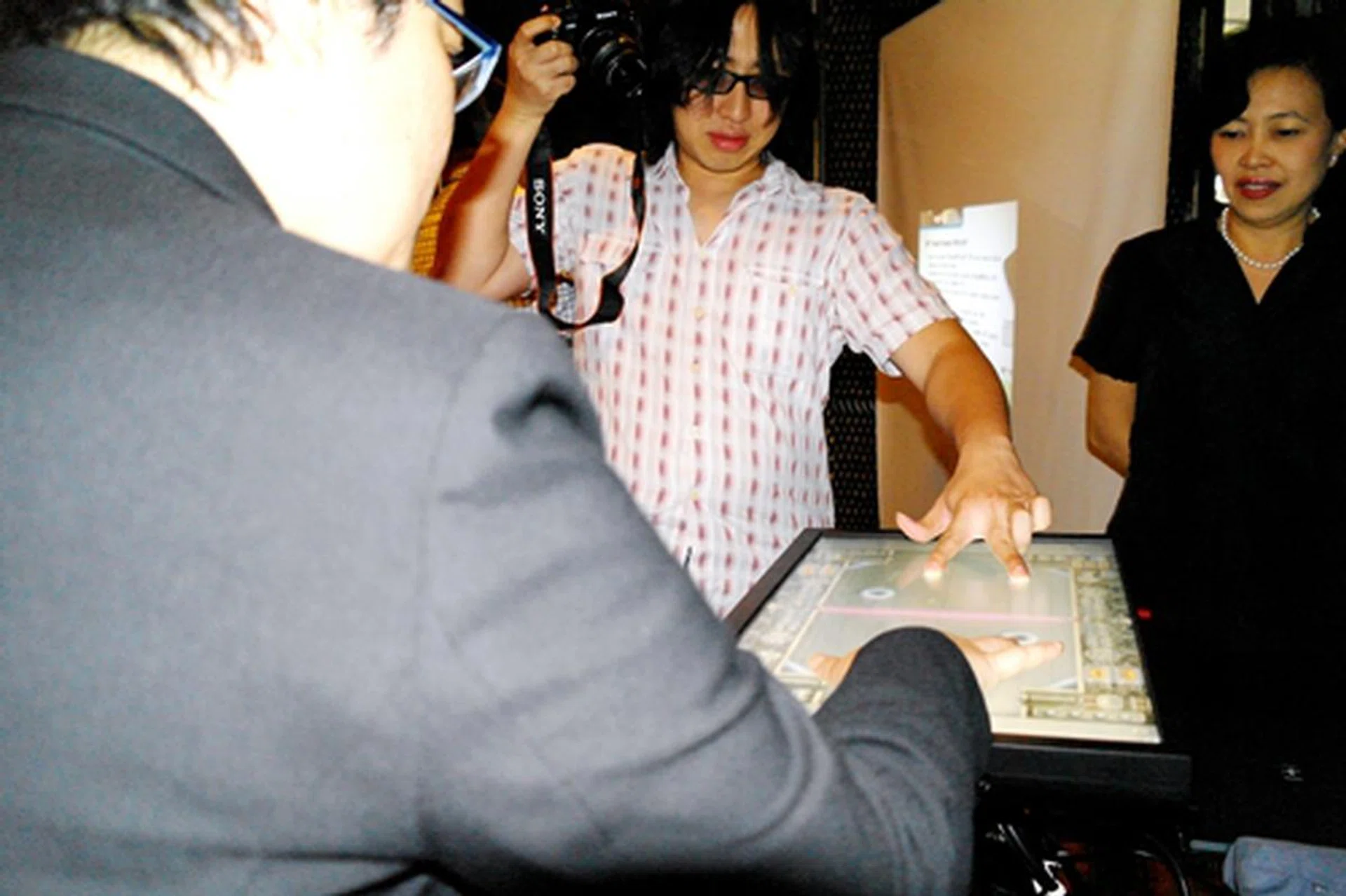 ... And later, supervising a game between the media to show off the screen's capabilities.