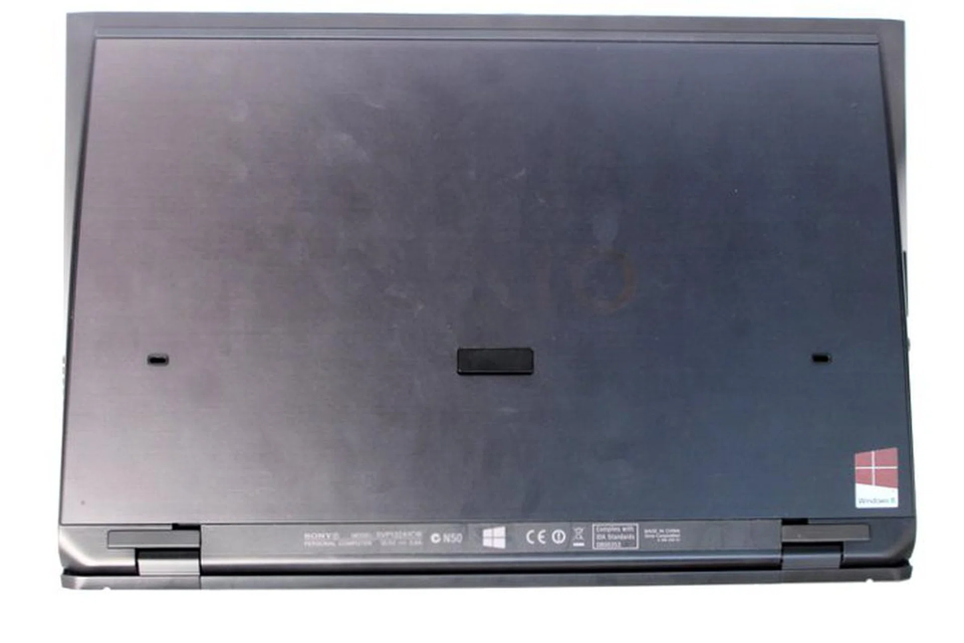 The bottom of the machine is clean and void of markings or screws, which means self-upgrading is out of the question and the battery is non-removable. For those curious, the heat vents are on the left side of the machine. All you can see at the bottom are latching slots for the optional sheet battery to extend on-the-go usage.