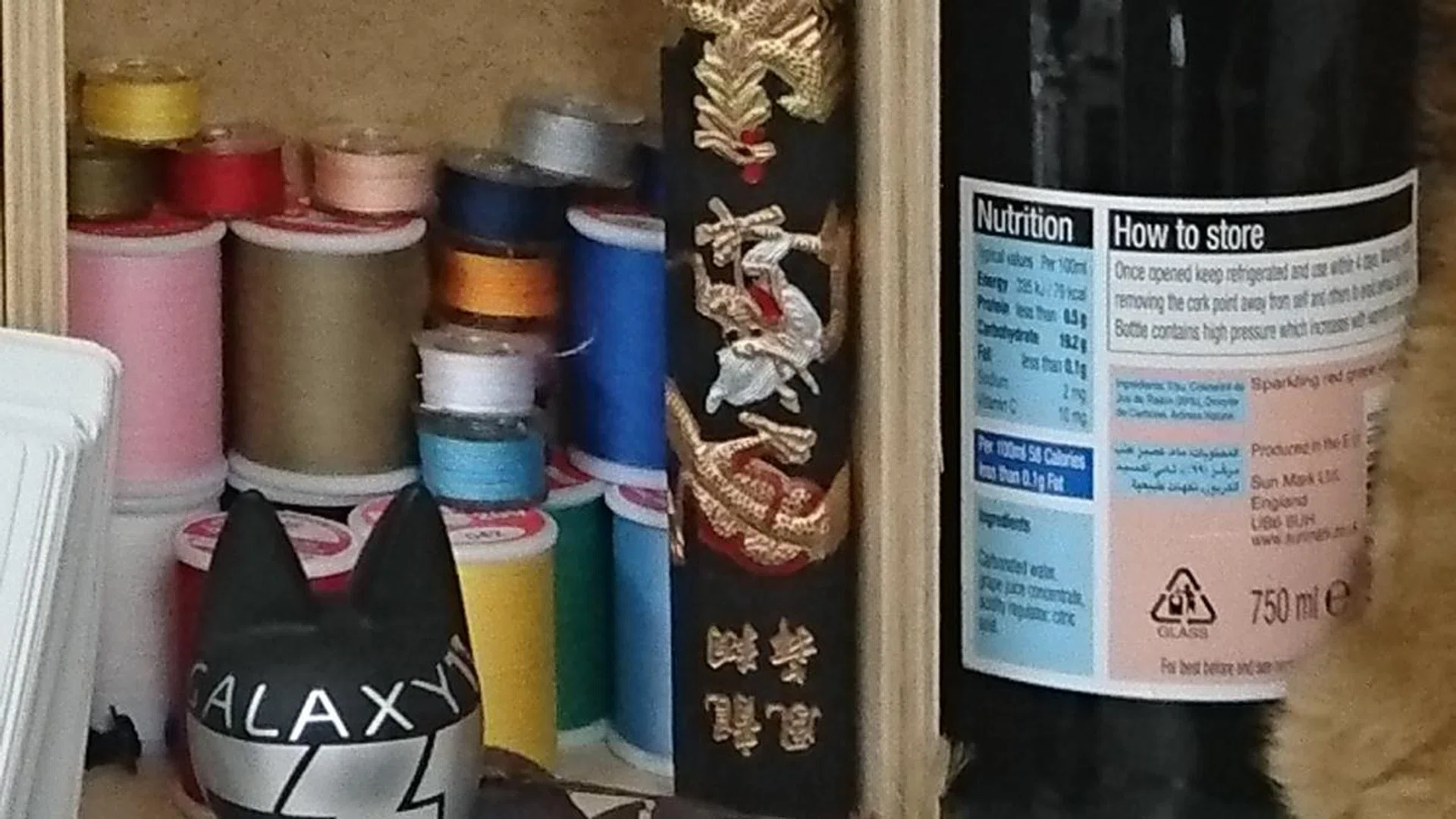 100% crop of Sony Xperia Z5 test image. Details are there but not entirely consistent - look out for differences in detail between the thread spools and bottle label.