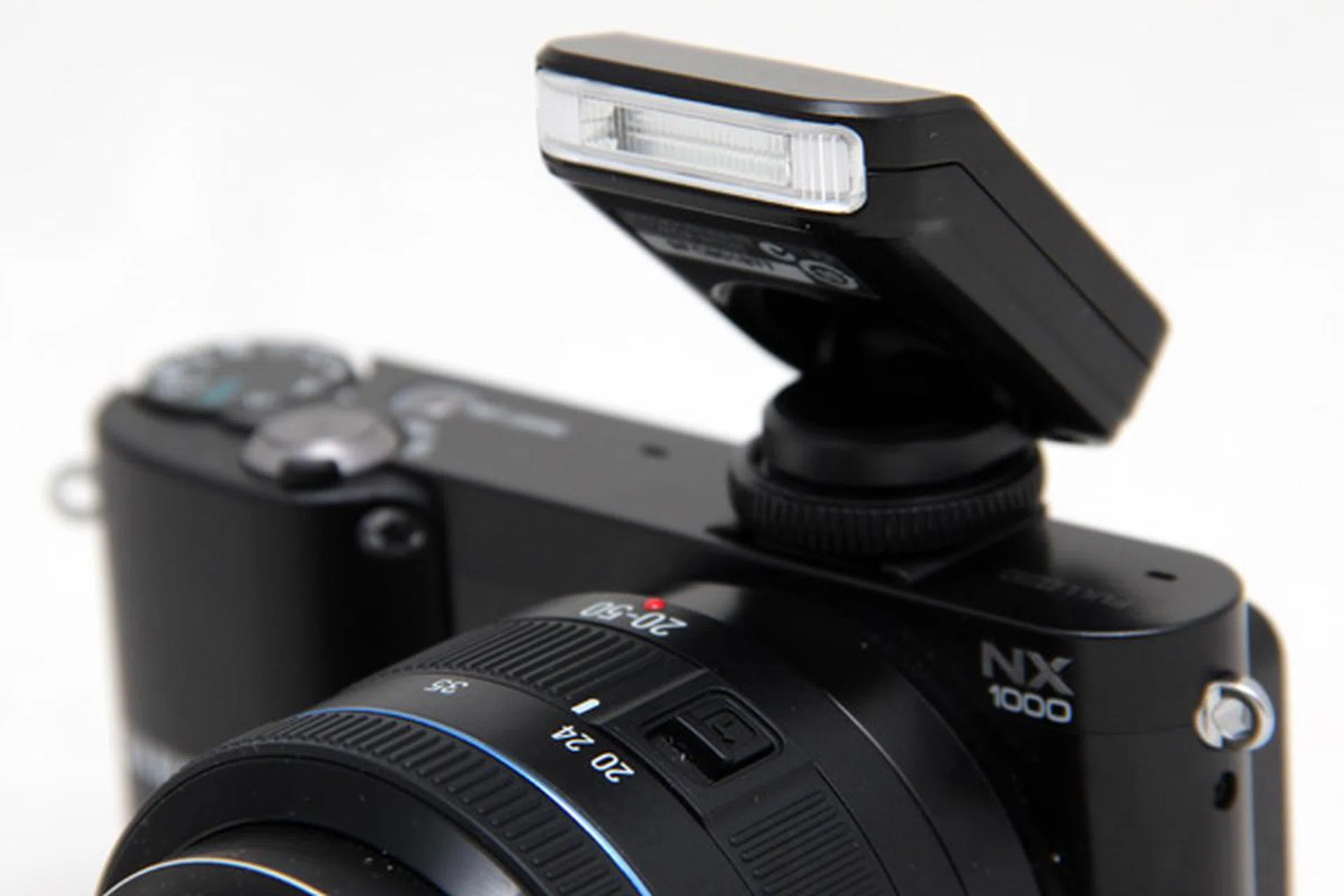 The flash attachment can be pushed down for stowing, but to shoot with flash you have to raise it.