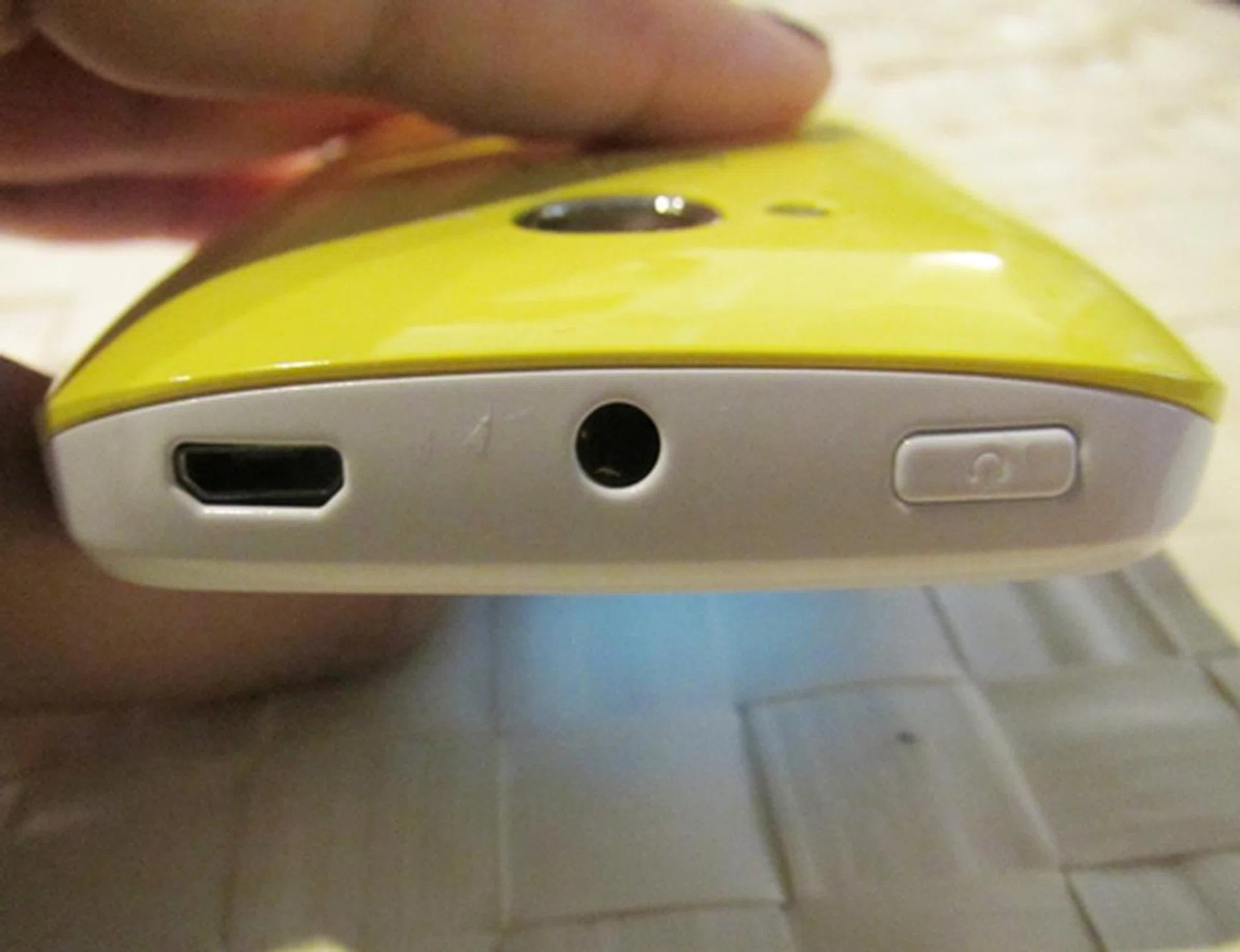 The phone's ports and power button are lined neatly on the top.