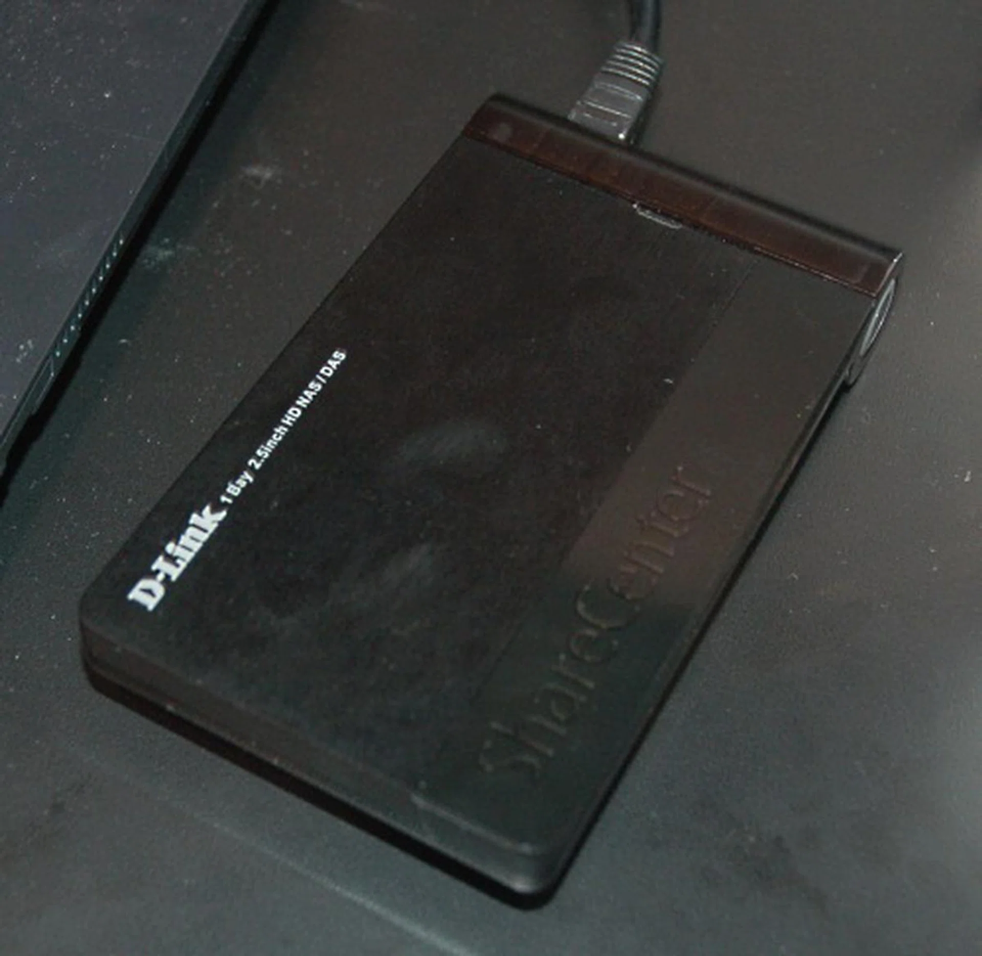 The prototype D-Link DNS-213 is a single-bay 2.5-inch ShareCenter NAS. All you need to do is to plug it into your router and it should take care of everything else, like serving files to your other networked PCs and even over the internet. No pricing info yet nor firm availability.