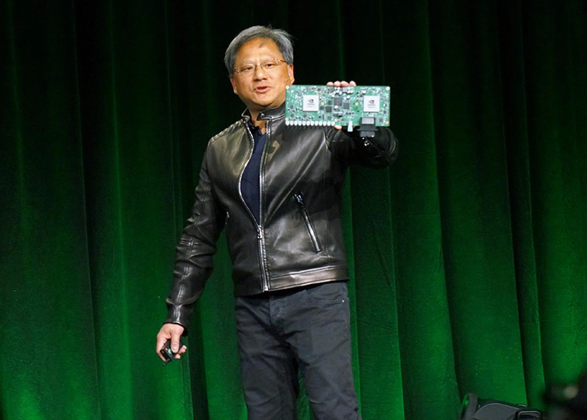 NVIDIA CEO Jen-Hsun Huang holding up the Drive PX "supercomputer for the car", which has in excess of 2 teraflops of compute performance.