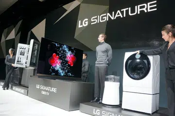The complete range of LG Signature equipment - a 4K HDR OLED TV, a refrigerator, a washing machine and an air purifier.