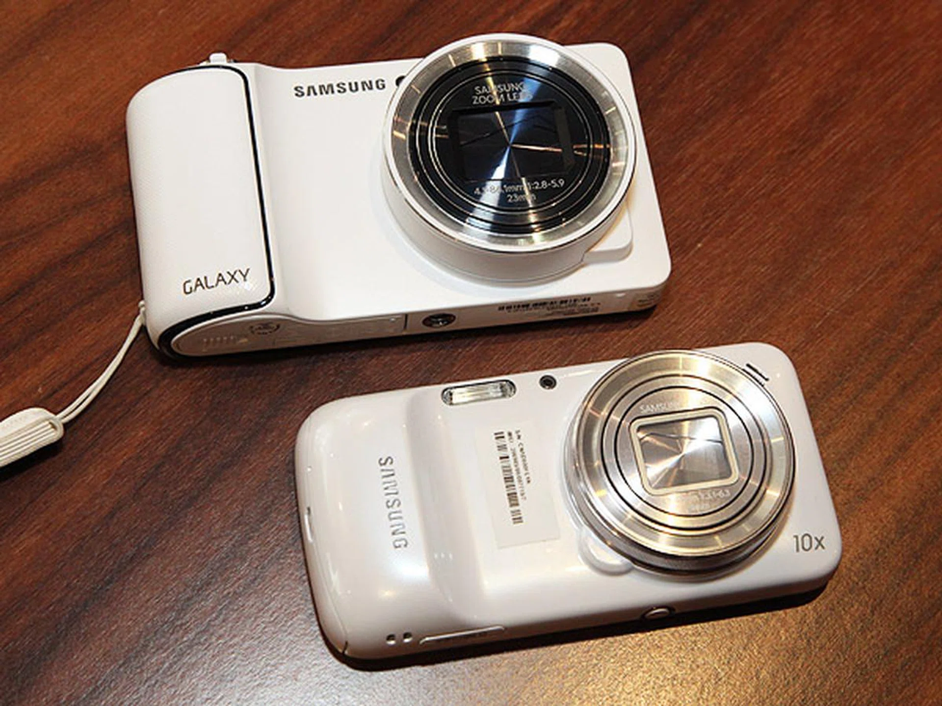 The new Galaxy S4 Zoom (below) compared with the older Samsung Galaxy Camera (above).