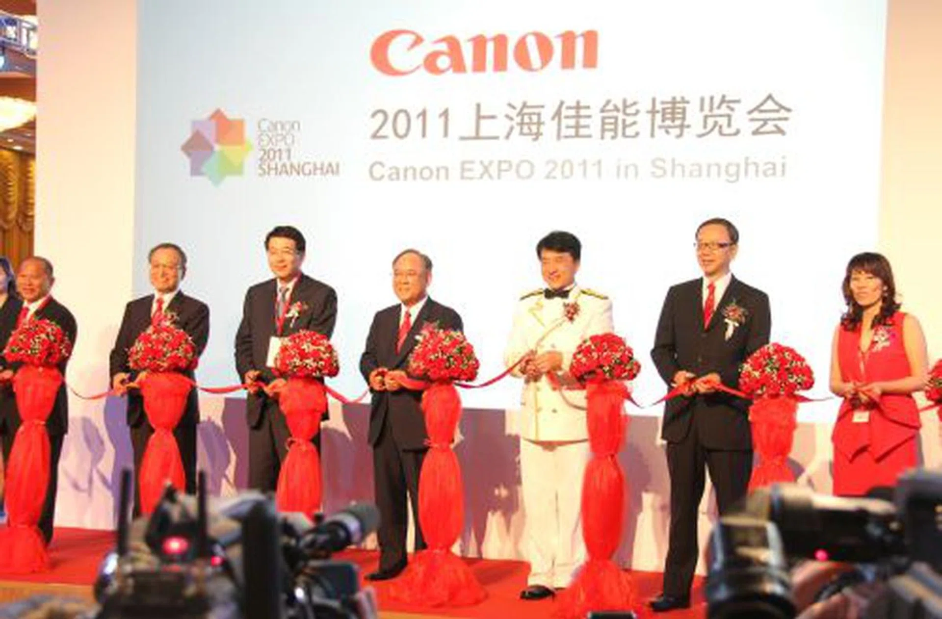 International star Jackie Chan (third from right) is the image ambassador for Canon at the EXPO in Shanghai. He jointly opened the EXPO 2011 event with Mr. Fujio Mitarai (fourth from right), Chairman of the Board and CEO of Canon Inc.; Mr. Tsuneji Uchida (second from left), President and COO of Canon Inc.; Mr. Hideki Ozawa (second from right), President of Canon Marketing Asia Group and President & CEO of Canon China;  and partners.