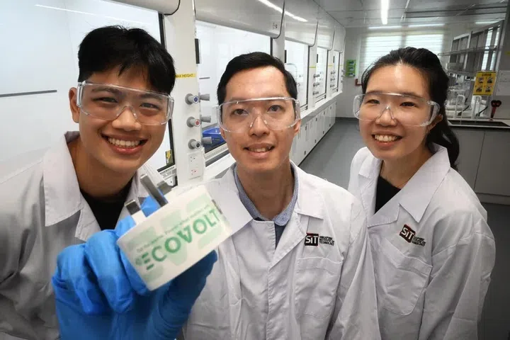 Image of Eugene Chia, Andrade Alvin Matthew and Pek Hai Lin holding up a eco plug.