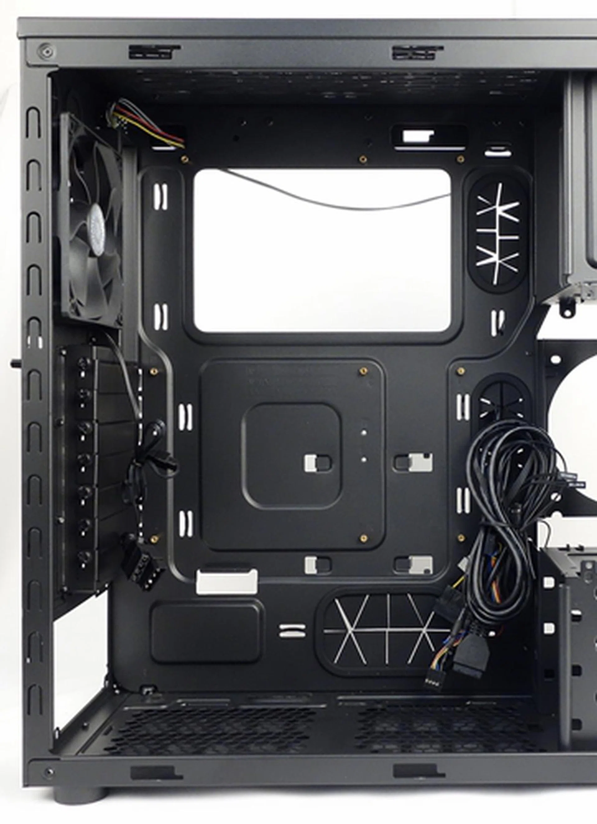 The motherboard tray has a large cutout for mounting CPU coolers. Its cable management cutouts are covered with flimsy rubber grommets.
