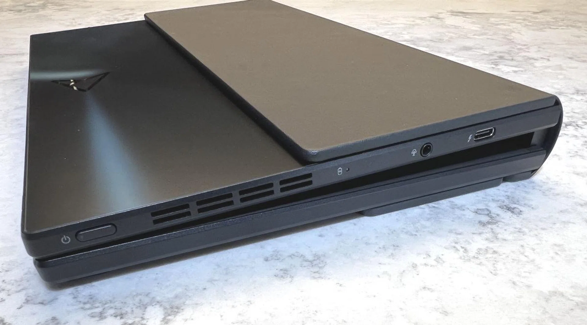 Basically the only ports you get are 2 x Thunderbolt 4 and 1 x commbi 3.5mm audio jack. This picture shows one Thunderbolt 4 port on the side, while the other port is on the top corner on another side of the chassis.