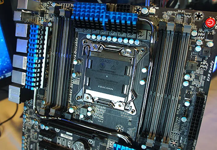 The LGA2011 CPU socket is flanked by four DIMM slots on each side.