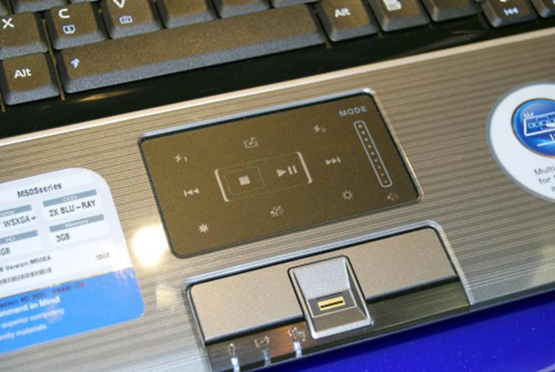  Based on the pictures, we're guessing there's probably a switch to change the touchpad to the multimedia mode which will allow you to control the multimedia functions via the touchpad.  