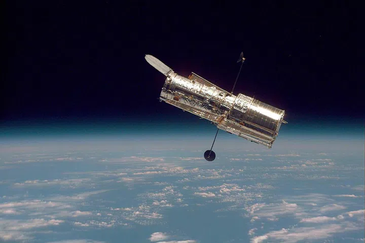 Image of Hubble against the Earth’s Horizon after its second servicing mission in 1997.