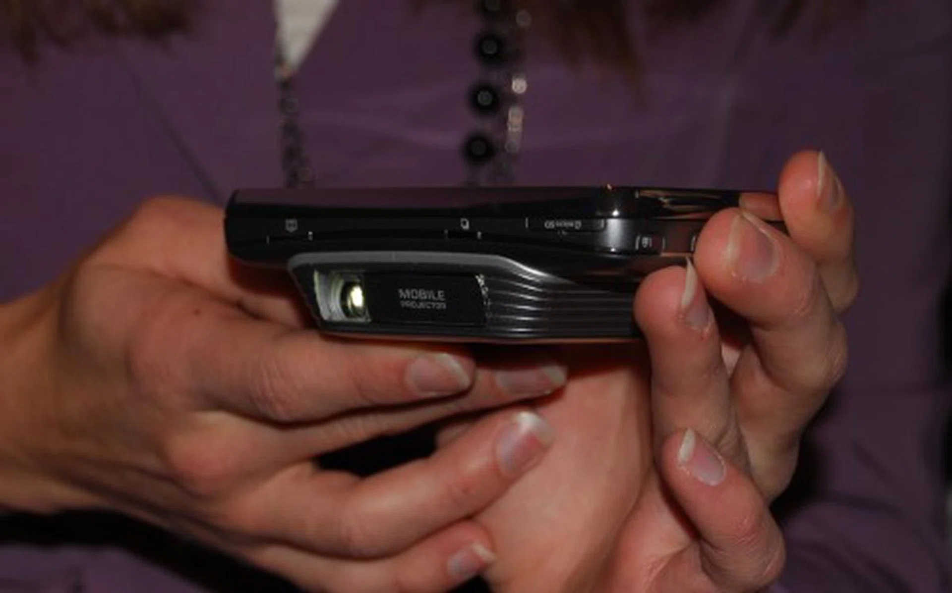 The WVGA Pico projector is an add-on unit to the mobile phone which has its own power pack and can be stowed away when not needed. This saves excess weight, size and battery life of the phone in day-to-day needs.