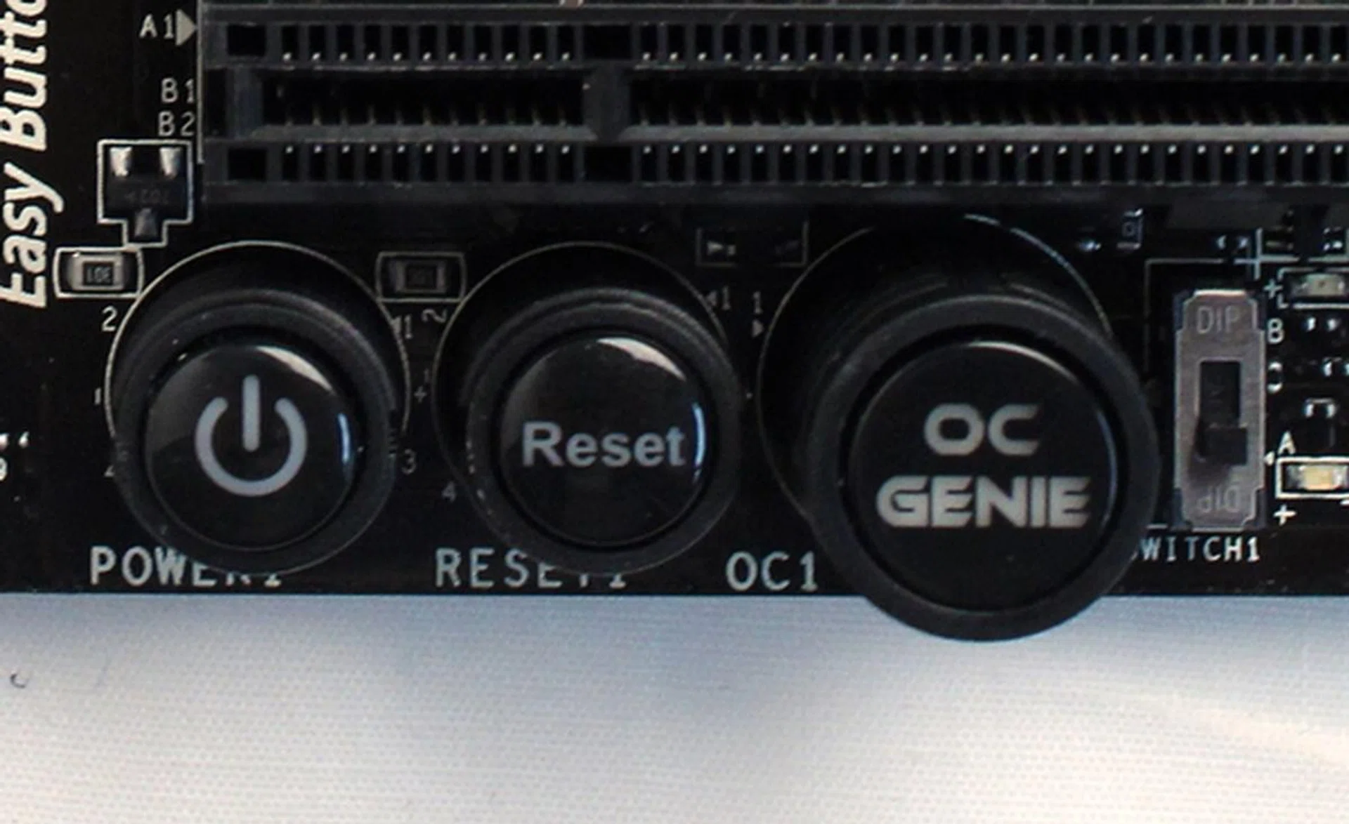 The DIP switch is called the OC Genie mode switch, when the switch is pushed down to the bottom edge of the board, the OC Genie is in Turbo mode. When it is pushed to the opposite side, OC Genie is in Gaming mode.