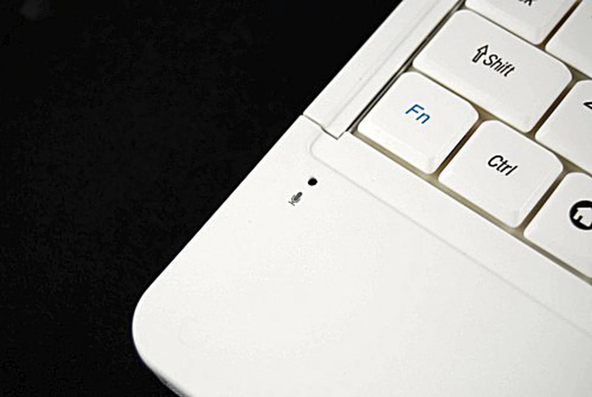 The microphone still remains at lower left corner of the keyboard, so don't rest your palm (and block the mic) while typing!