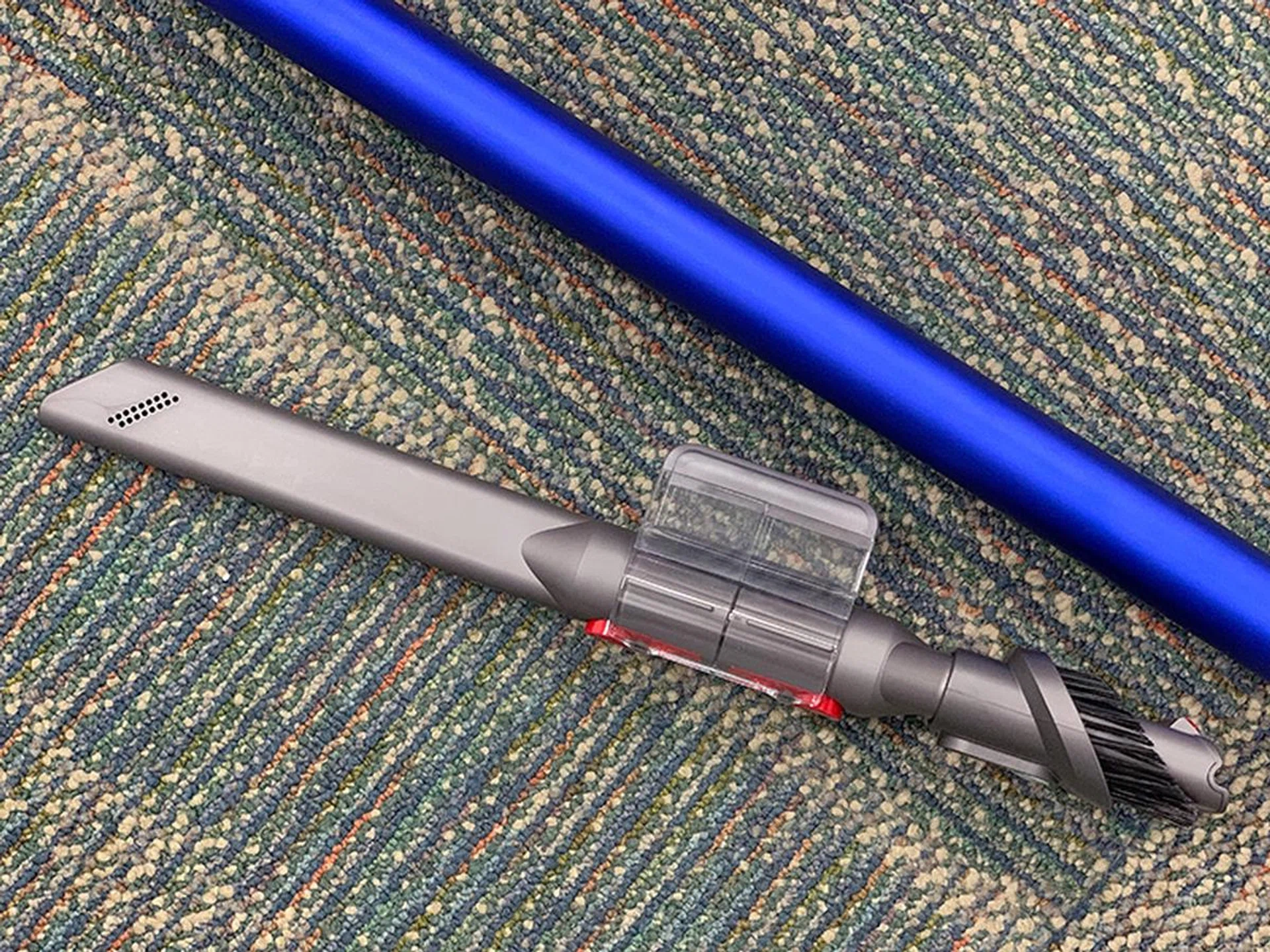There's a plastic clip that you can attach to the extension pole for holding the smaller tools and brushes.