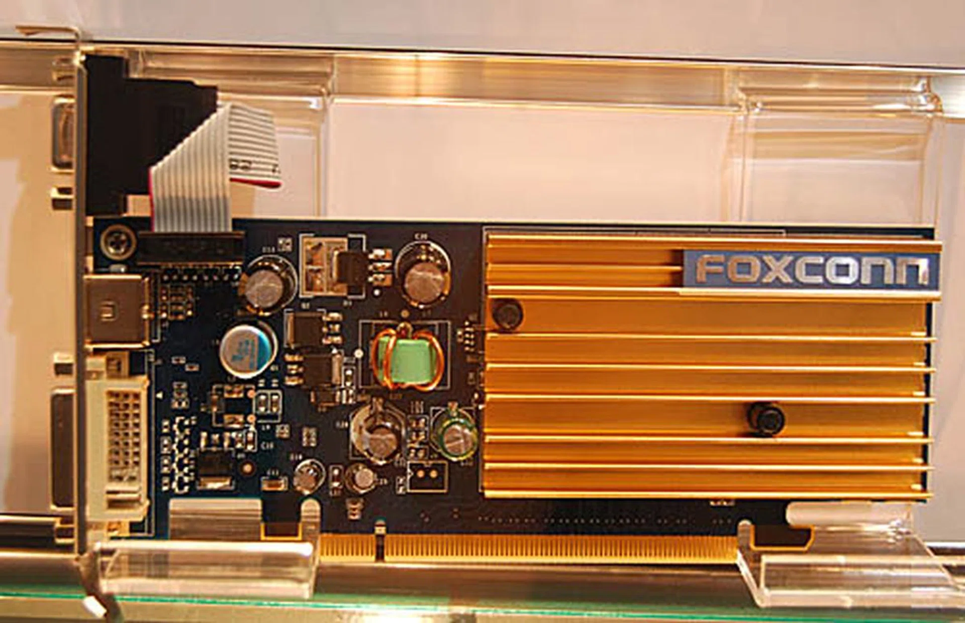  Introduced recently and without the usual fanfare associated with graphics chipsets is the extremely low end GeForce 7200 series. With only 4 pixel pipelines and a 64-bit memory bus, this Foxconn GeForce 7200 GS may have 256MB of DDR2 memory but is actually only a step above integrated graphics performance-wise.  