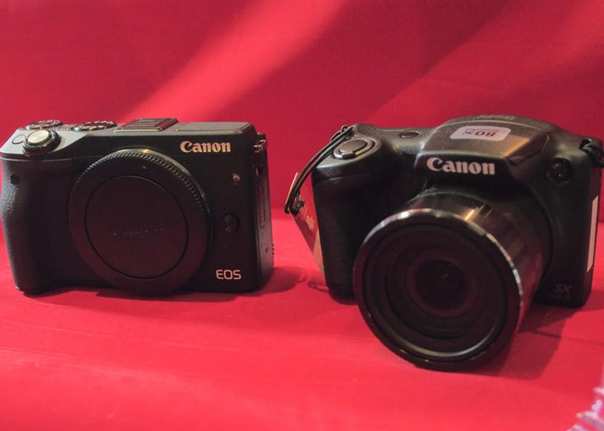 The PowerShot SX410 IS next to the EOS M3 (without lens mounted)